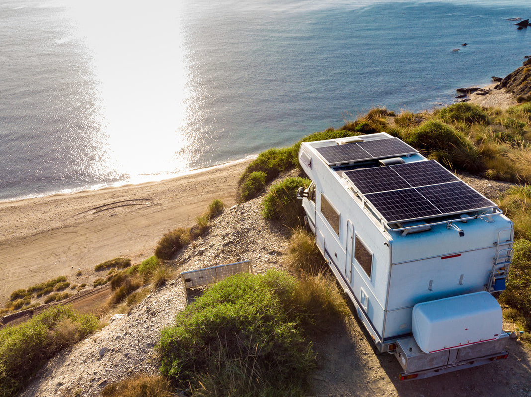 RV overlooking the ocean with solar panels and the best solar generator for an RV