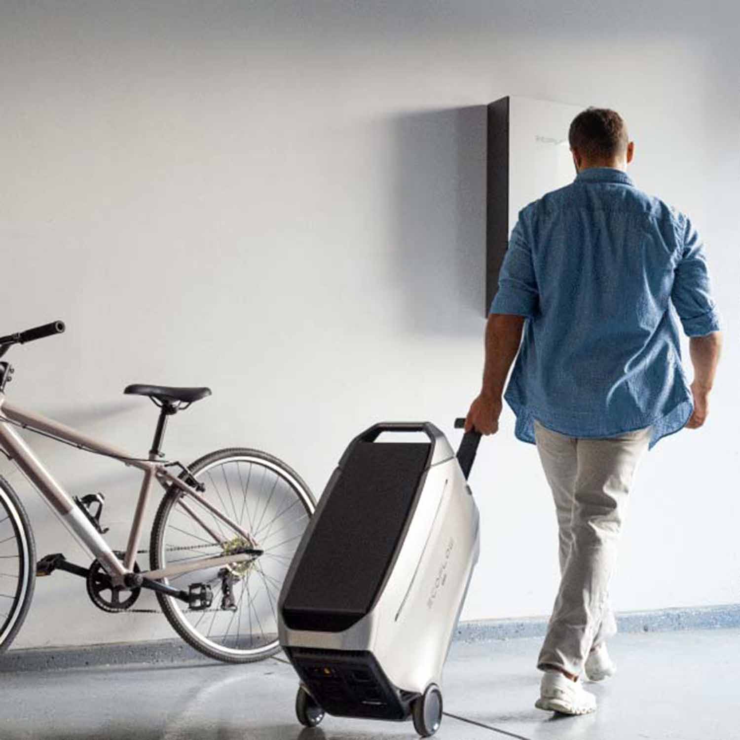 man pulling his best-rated solar generator with portable wheels