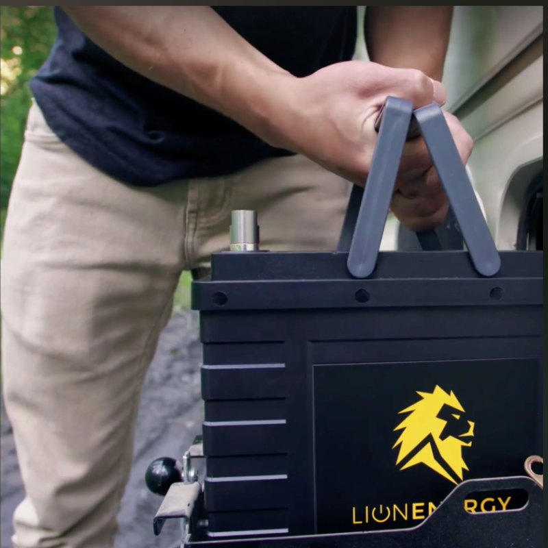 Man Carrying Lion Energy UT 1300 Battery 